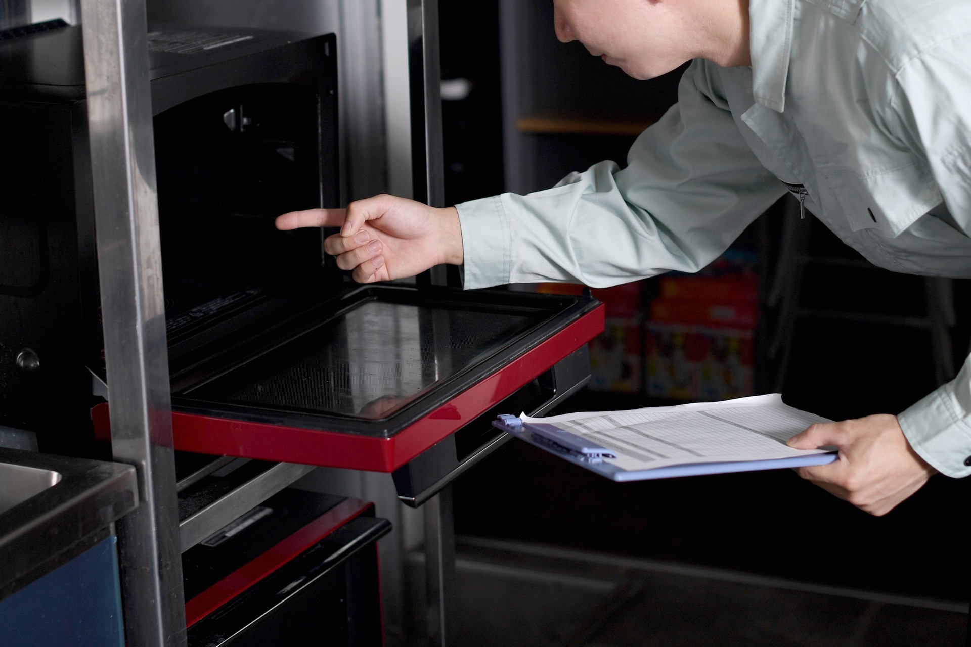 Male worker checking the oven/range